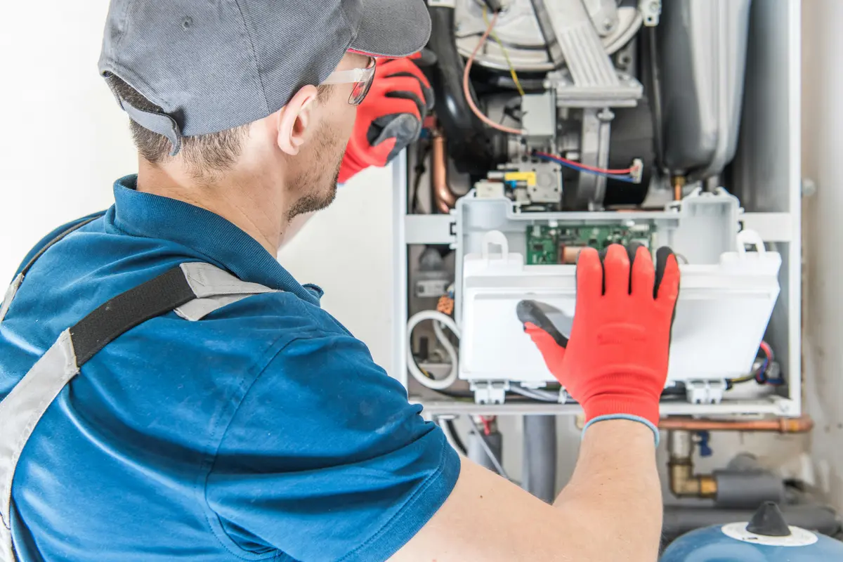 HVAC technician performing annual maintenance on a boiler in Austin