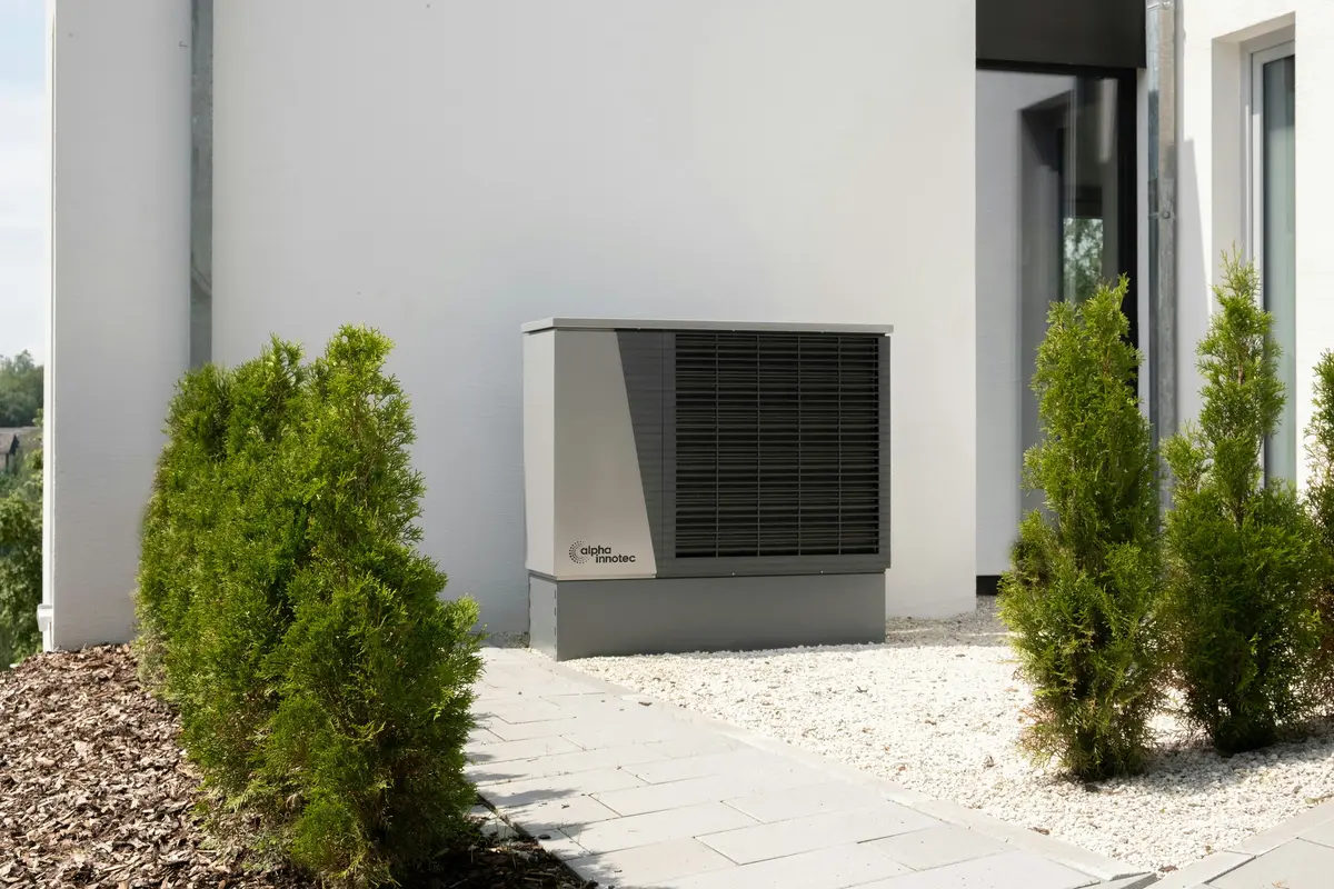 Cold-climate heat pump outdoor unit mounted on Austin home exterior