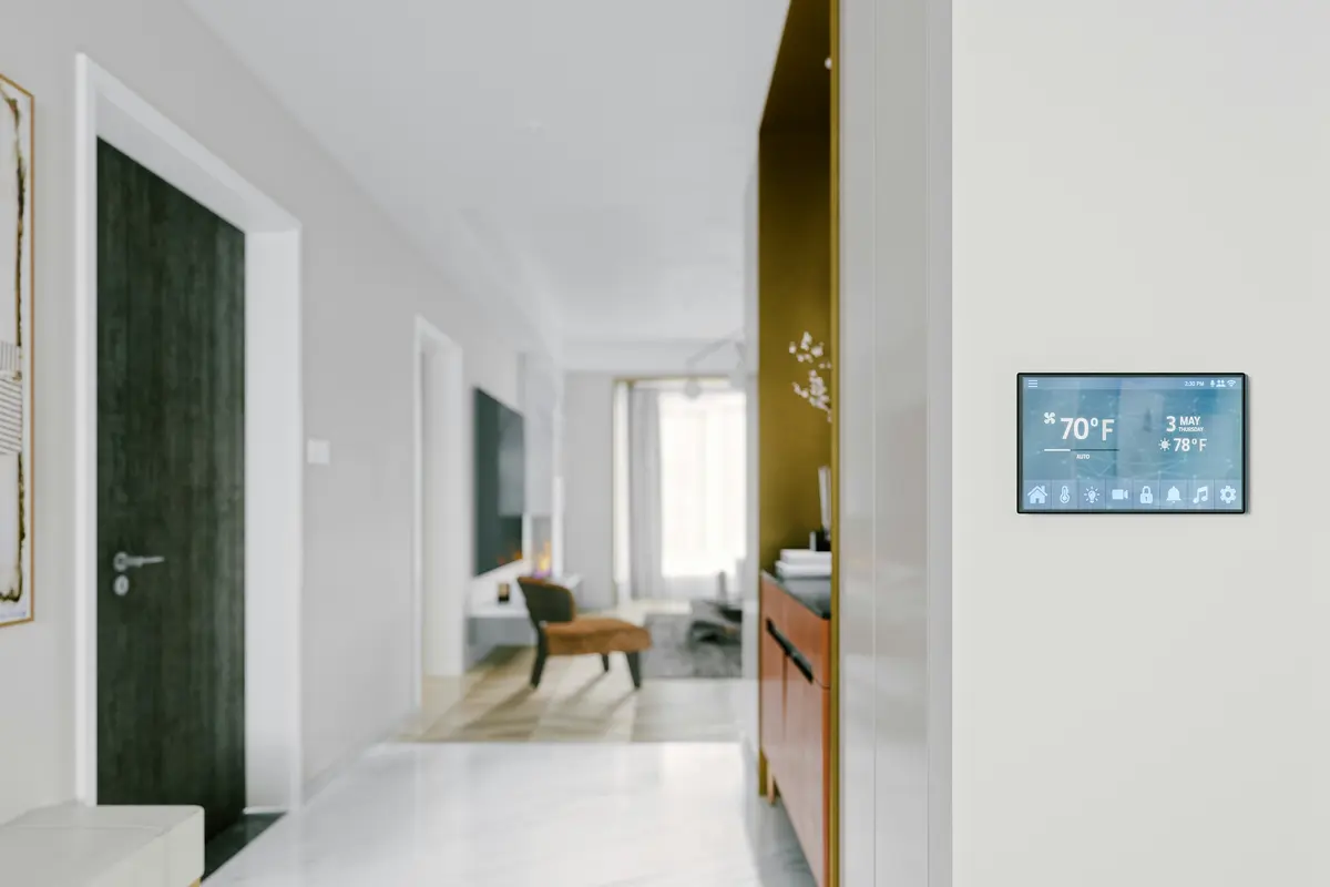 Digital wall thermostat controlling home HVAC system