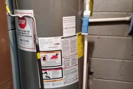 Water heater tank inspection in a Austin home